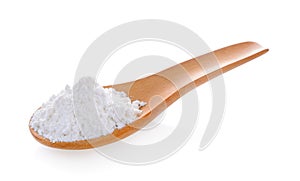 Pile of white wheat flour in wooden spoon