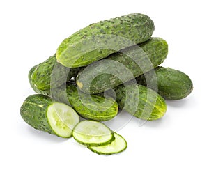 Pile of whole and sliced cucumbers (Cucumis sativus)