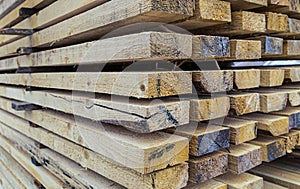 Pile wide boards drying of construction materials with a perspective view of many beams