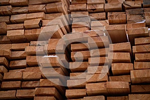 A pile of wood with a layer of snow on top, showcasing the wintry weather conditions. A tall and sturdy pile of wooden