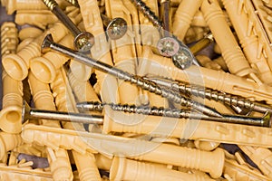 Pile of wood screws with appropriate plastic anchors, close-up
