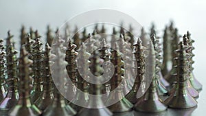 Pile of wood screws isolated on silver background