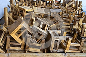 Pile of wooden chairs old that is no longer used