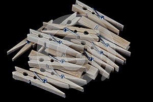 Pile of Wooden Clothes Pegs on a Black Surface