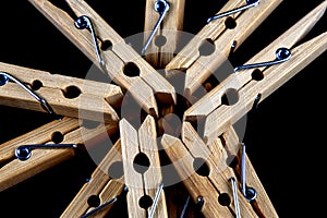 Pile of Wooden Clothes Pegs Closeup View on a Black Surface