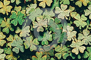 Pile of wooden green four-leaf clovers photo