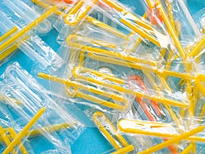 Pile of yellow drinking straws on a blue background