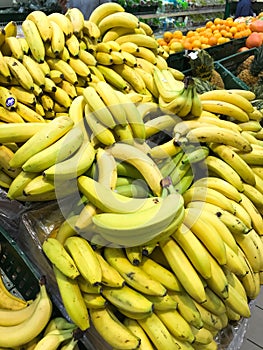 A pile of yellow fruit bananas in a store for sale