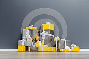 Pile of yellow and grey Christmas gifts