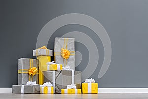 Pile of yellow and grey Christmas gifts