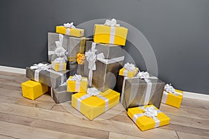 Pile of yellow and grey Christmas gifts