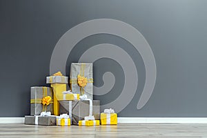 Pile of yellow and grey Christmas gifts