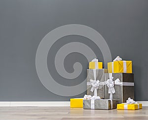 Pile of yellow and grey Christmas gifts