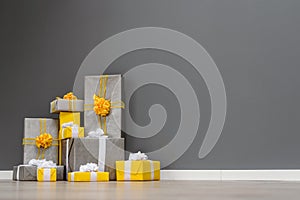 Pile of yellow and grey Christmas gifts