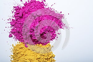 Pile of yellow and pink color holi powder isolated on white background