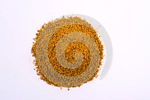 A pile of a yellow spice mix for kari . Isolated on white background.