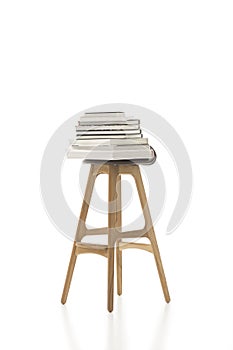 Piled Books on Top of Tall Single Chair