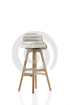 Piled Books on Top of Tall Single Chair photo