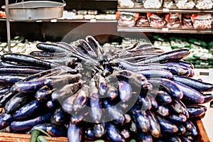 Piled eggplant on display for sale at supermarket