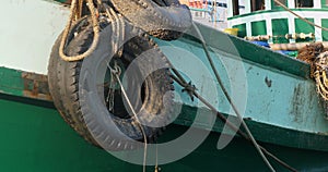 piled nets and.ropes dominates the deck of the departing boat