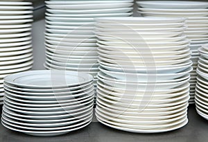 Piled stack of clean dishes plates photo