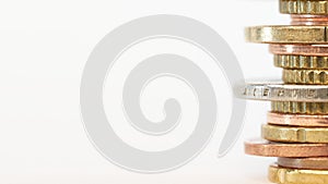 Piled up euro coins on table with white background