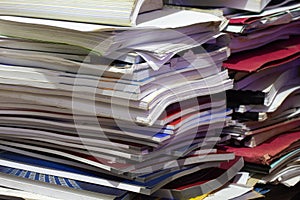piles of books, magazines and waste paper