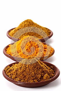 Piles of bright Curry Powder and tumeric