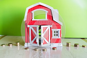 Piles of coins by red house miniature