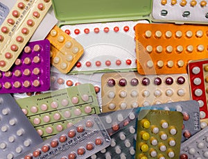 Piles of colorful birth control pills photo