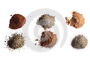 Piles of different spices isolated on white background flat lay