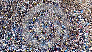 Piles of empty bottles, bags and other plastic in the garbage dump. Aerial.