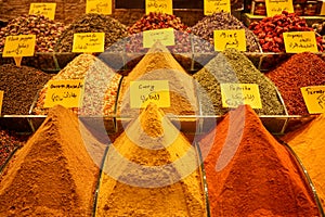 Piles of fresh bright colorful local turkish spice ingredient in Istanbul spice market including curry, paprika, masala, mint