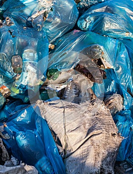 Piles of garbage in plastic bin bags