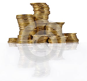 Piles of gold coins on a white