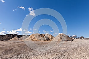 Piles of Gravel at Construction Site under Bright Blue Sky