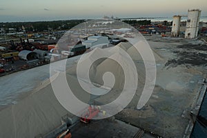 Piles of gravel and other small stones for building purposes situated in industrial zone of Nassau.