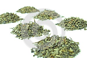 Piles of green tea, isolated on white