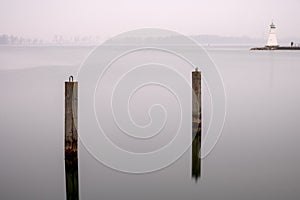 Piles and lighthouse in calm water