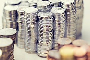 Piles of metalic different currencies in different colors photo