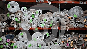 Piles of new rolls of carpet in a store warehouse. Carpet rolls stacked at store. Move camera