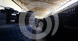 Piles of new tires in tyre warehouse in car garage