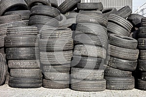 Piles of old rubber tyres with worn out threads