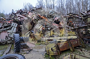 Piles of old rusty soviet crushed trucks in scrap metal yard