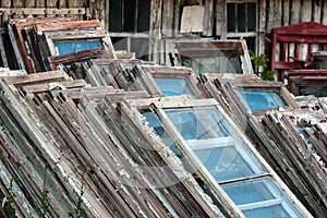 Piles of old wooden frames and windows