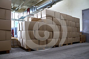 Piles of paper boxes with goods in storage