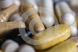 Piles of pills and capsule on white background. Selective focus