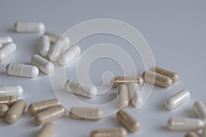 Piles of pills and capsule on white background. Selective focus