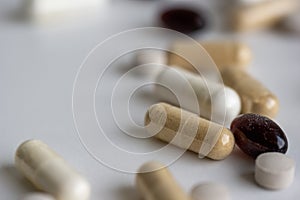 Piles of pills and capsule on white background. Selective focus