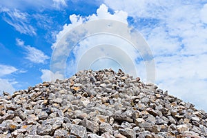 Piles of rocks at Construction Site under Bright Blue Sky.